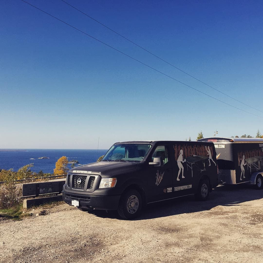 Tiger's wrapped truck and trailer parked beside the Pacific Ocean.