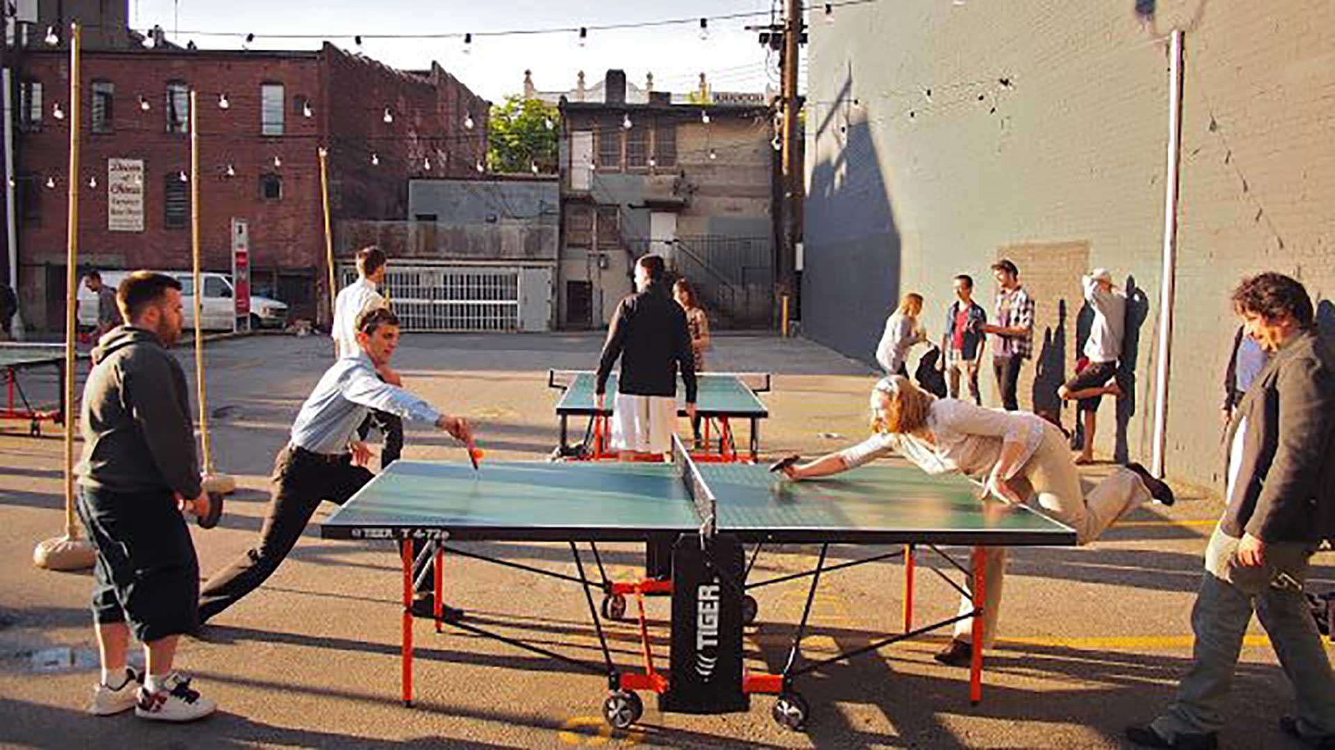 People playing on the first Tiger Expo table at an outdoor Vancouver event.